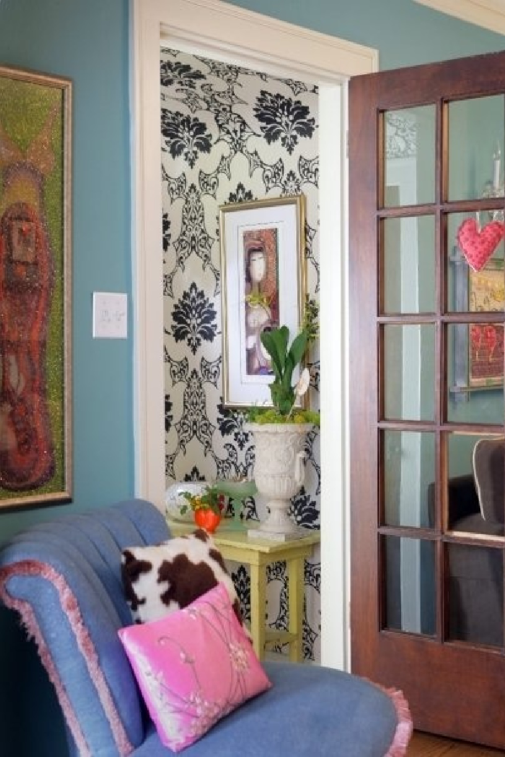 Turquoise wall in a groovy foyer with eclectic flea market style - Jenny Sweeney.