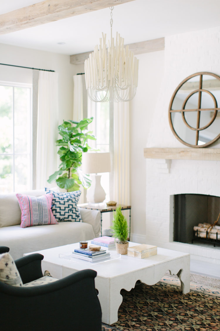 Beautiful and simple white fireplace in a modern farmhouse living room with design by Kate Marker in Barrington, IL. Come enjoy encouraging love quotes and timeless decor inspiration! #modernfarmhouse #livingroom #fireplace