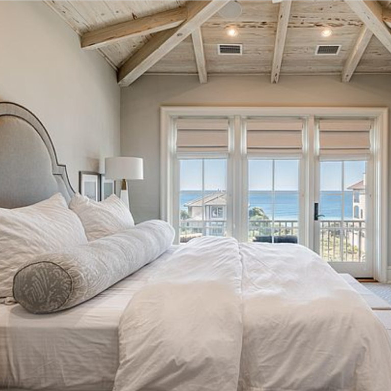 Timeless and tranquil coastal bedroom with rustic wood ceiling in a luxury Inlet Beach, FL home. #bedroomdesign #coastalbedroom