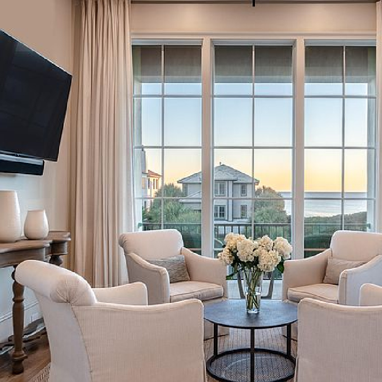 Cozy conversation area with white slope arm club chairs in a luxurious Inlet Beach, FL home.