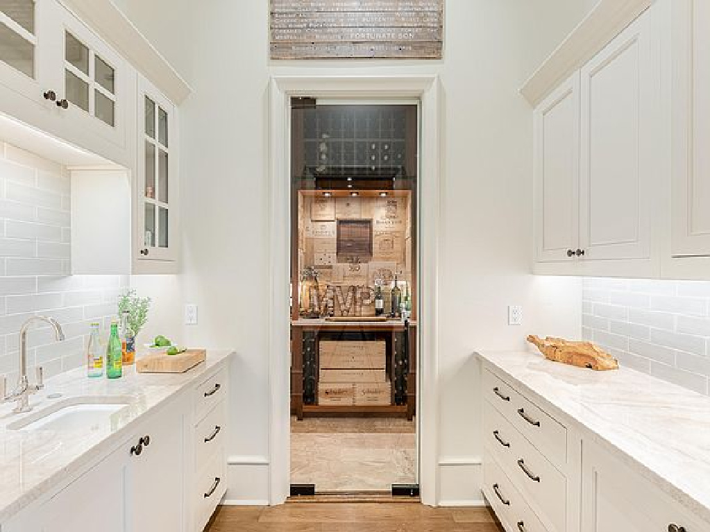 Charming white cabinetry in a butler pantry of a coastal home in Inlet Beach, FL. #butlerpantry #coastalstyle