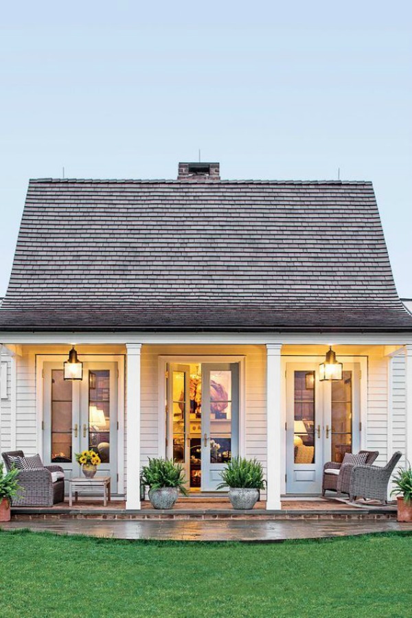 Adorable white house exterior with three sets of French doors - Lucy Williams.