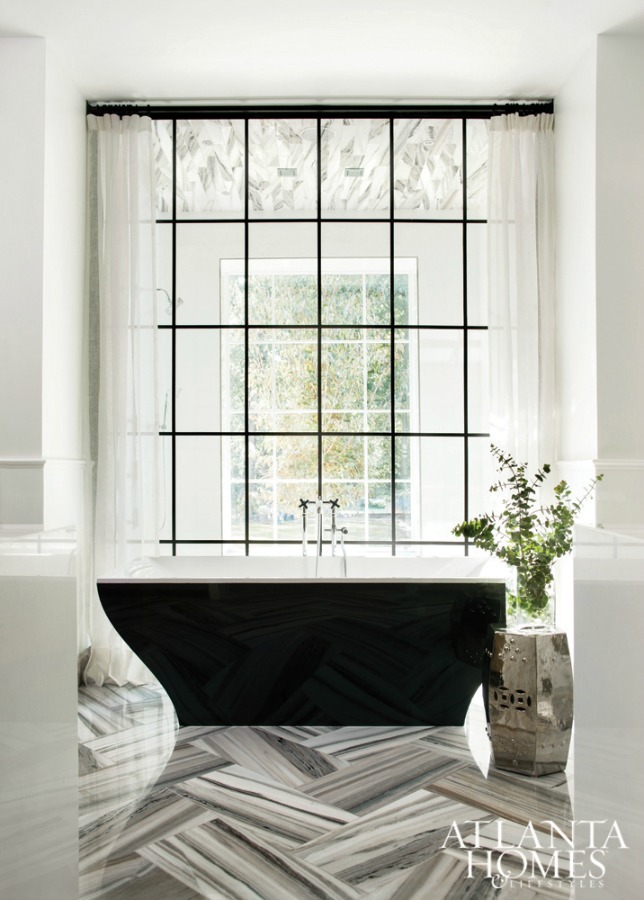 Luxurious black and white bathroom with soaring window and design by Sherry Hart. #bathroomdesign #luxuriousbathroom #blackandwhite #interiordesign