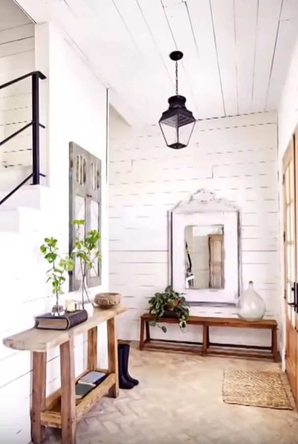 Chip and Joanna's Waco farmhouse entry with shiplap on walls, barn style lantern, and rustic decor. #fixerupper #joannagaines #farmhouse #entry #shiplap