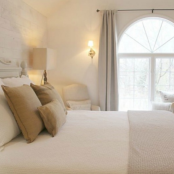 Hello Lovely Studio's pale neutrals, serene decor, and an ethereal mood permeate this French Nordic style bedroom with reclaimed wood statement wall - Hello Lovely Studio. #serenedecor #NordicFrench #bedroomdecor #frenchnordicstyle