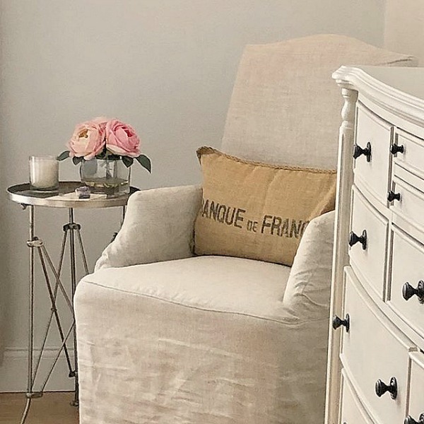 Hello Lovely Studio's Nordic French bedroom with Belgian linen accent chair and campaign style table. #nordicfrenchstyle #bedroomdecor #serenedecor #interiordesign #europeancountry