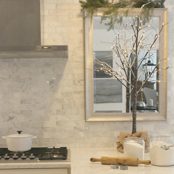 Polished marble subway tile backsplash and Viatera Minuet quartz counter in Hello Lovely Studio's French Nordic style white Shaker kitchen. #nordicfrench #kitchendesign #viateraminuet #marblesubwaytile