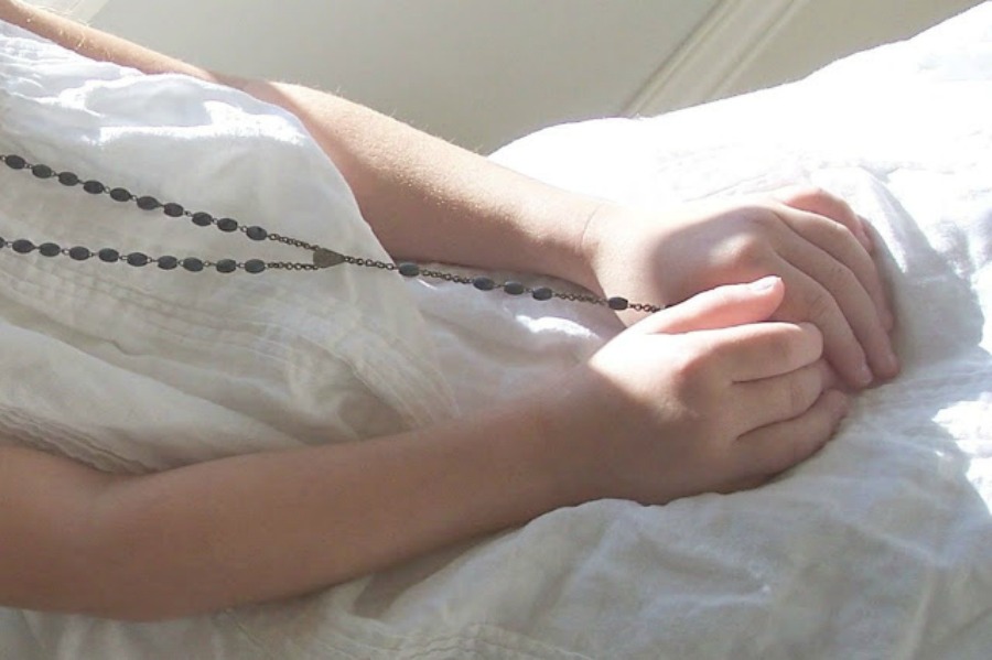 Child holding rosary beads - photo by Michele of Hello Lovely Studio. #rosary #child #hands