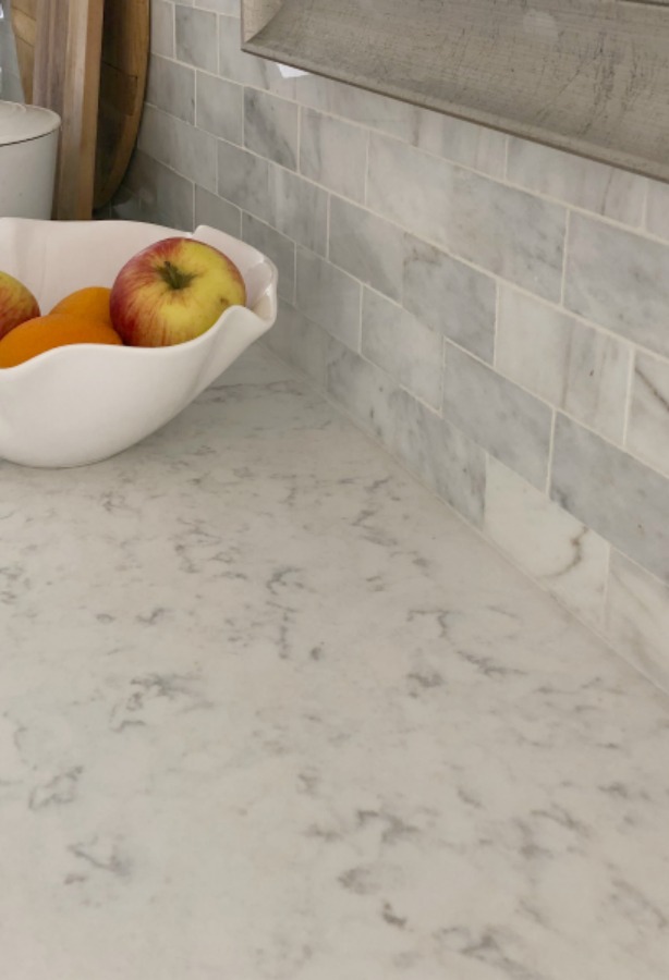 My simple white Shaker kitchen with white oak floors, marble subway backsplash, Viatera quartz "Minuet" counters, and a window seat. #hellolovelystudio #whiteshakerkitchen #kitchendesign #kitchendecor #classickitchen #viateraquartz #minuet