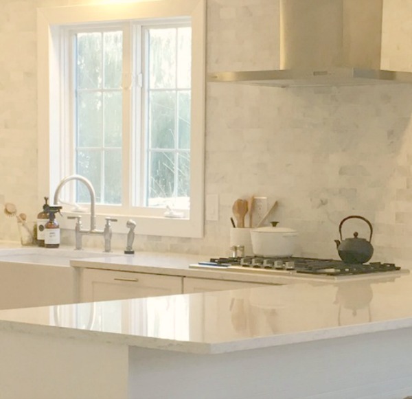 My simple white Shaker kitchen with white oak floors, marble subway backsplash, Viatera quartz "Minuet" counters, and a window seat. #hellolovelystudio #whiteshakerkitchen #kitchendesign #kitchendecor #classickitchen #viateraquartz #minuet