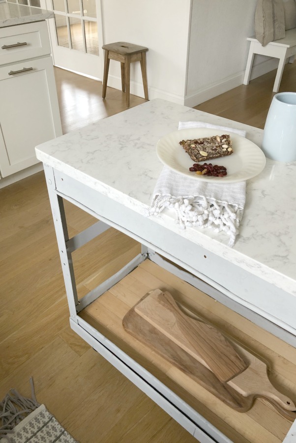 My simple white Shaker kitchen with white oak floors, marble subway backsplash, Viatera quartz "Minuet" counters, and a window seat. #hellolovelystudio #whiteshakerkitchen #kitchendesign #kitchendecor #classickitchen #viateraquartz #minuet