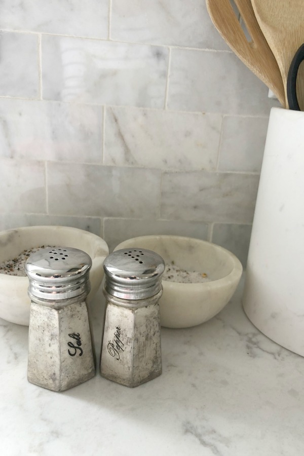 My simple white Shaker kitchen with white oak floors, marble subway backsplash, Viatera quartz "Minuet" counters, and a window seat. #hellolovelystudio #whiteshakerkitchen #kitchendesign #kitchendecor #classickitchen #viateraquartz #minuet