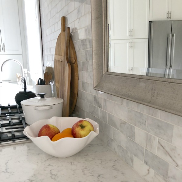 My simple white Shaker kitchen with white oak floors, marble subway backsplash, Viatera quartz "Minuet" counters, and a window seat. #hellolovelystudio #whiteshakerkitchen #kitchendesign #kitchendecor #classickitchen #viateraquartz #minuet