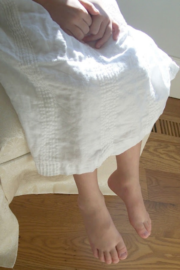 Child in white dress with bare feet dangling from chair - photo by Michele of Hello Lovely Studio. #feet #serene