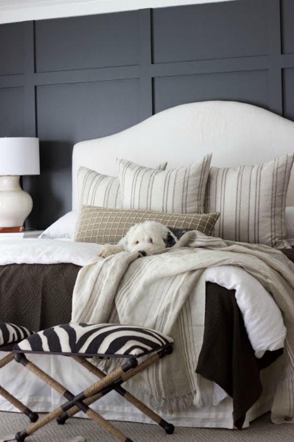 Dark grey paneled walls in a beautiful neutral bedroom designed by Sherry Hart. #benjaminmoore #ironmountain #darkgrey #greypaintcolors