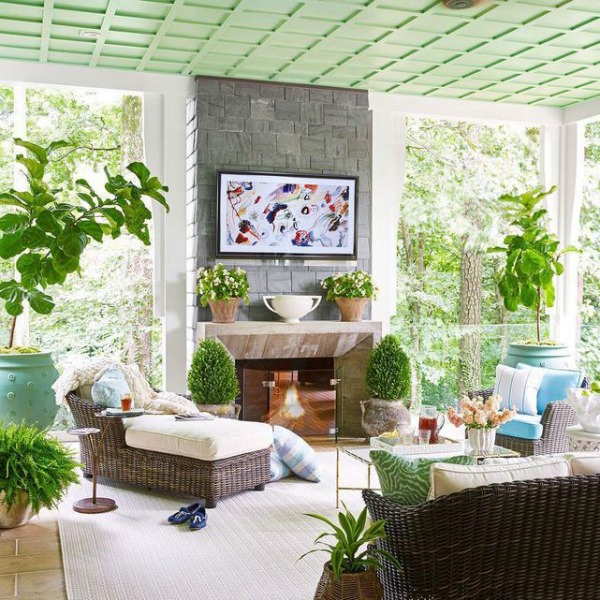 Green painted ceiling in an eclectic and colorful porch in the House Beautiful Whole Home - interior design by Sherry Hart.