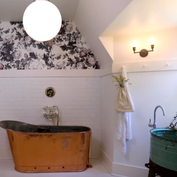 Ellie Cashman Summer Squall in Daylight White wallpaper in a white bathroom with vintage chic style by Leanne Ford. #bathroomdesign #vintagestyle #leanneford #copperbathtub #elliecashman