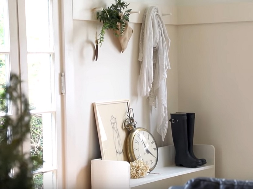 Shaker style peg rail above a vintage white wood bench in a cottage's entry. Renovation by Leanne Ford on Restored by the Fords - The Smith Project. #leanneford #entry #shakerstyle #cottagestyle