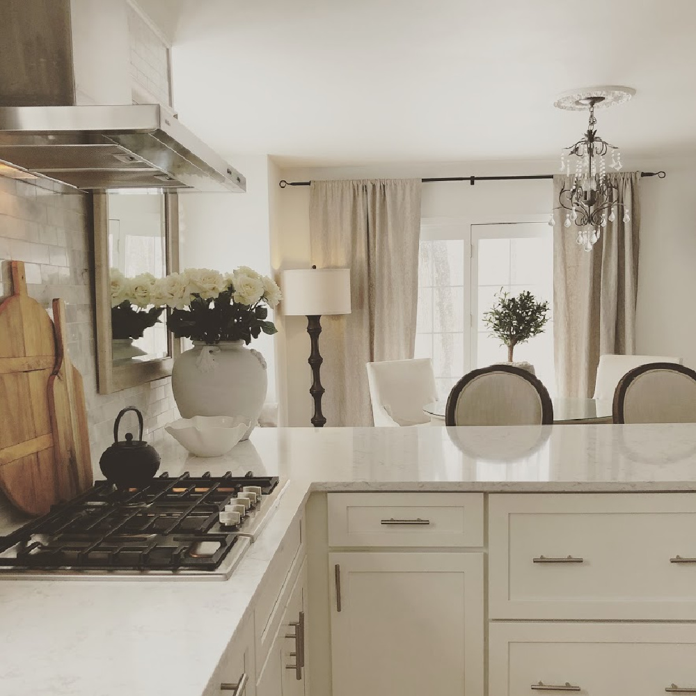 White serene Shaker kitchen with Viatera Minuet quart counters, Bosch cooktop, and modern French influence - Hello Lovely Studio. #modernfrench #whitekitchens #viateraminuet #whitequartz #kitchendesign