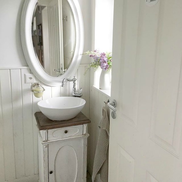 Charming French Nordic small powder bath with vessel sink and all white decor - Villa Jenal. #swedishstyle #frenchnordicliving #bathroomdesign #scandistyle