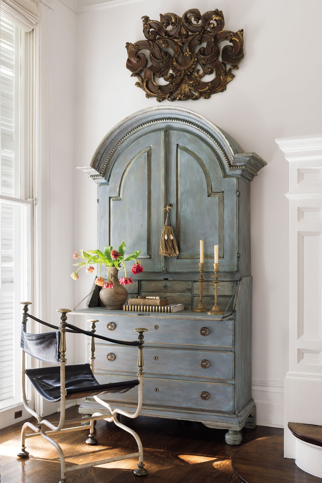 Beautiful blue 18th century Swedish secretary and vintage Savonarola chair make a stair landing functional for storage and correspondence. Tara Shaw designed this space. #tarashaw #swedishsecretary #swedishantiques #interiordesign #oldworldstyle #traditionaldecor