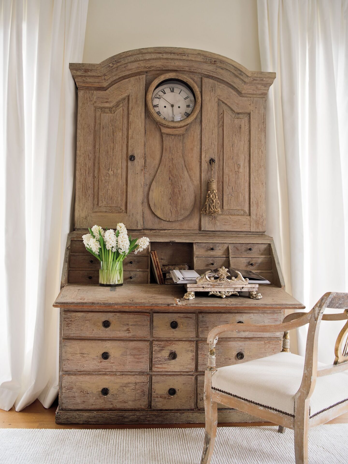 An 18th century clock secretary in a Tara Shaw designed guest room has breathtaking patina and functions for modern life. #tarashaw #swedishantiques #europeanantiques #swedishsecretary #18thcentury #oldworldstyle #elegantdecor