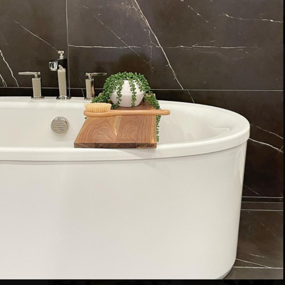 Black marble in a bathroom with soaking tub and wood board - @refineddesignstagingllc. #bathroomdesign #blackandwhite #blackmarble