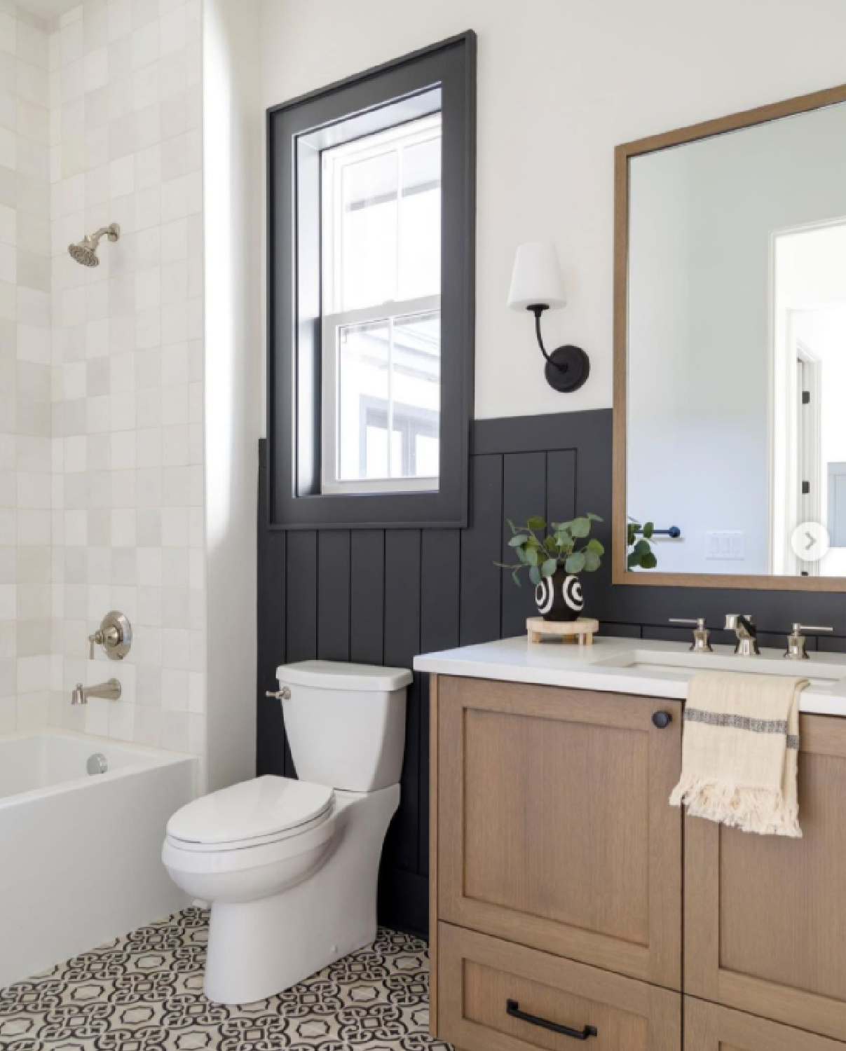 Black and white bathroom design with natural wood vanity and zellige tiles - design by Judith Balis. #blackandwhite #bathroomdesign #bathroomdecor