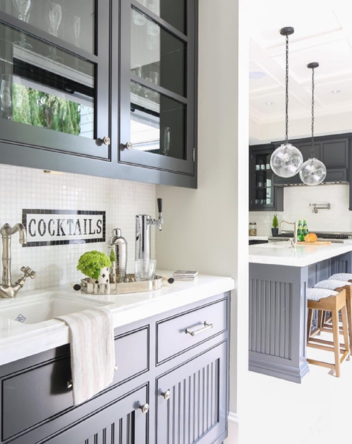 Black kitchen cabinets with beadboard detail in a beautiful kitchen - @pattersoncustomhomes. #blackandwhite #kitchendesign #blackcabinets