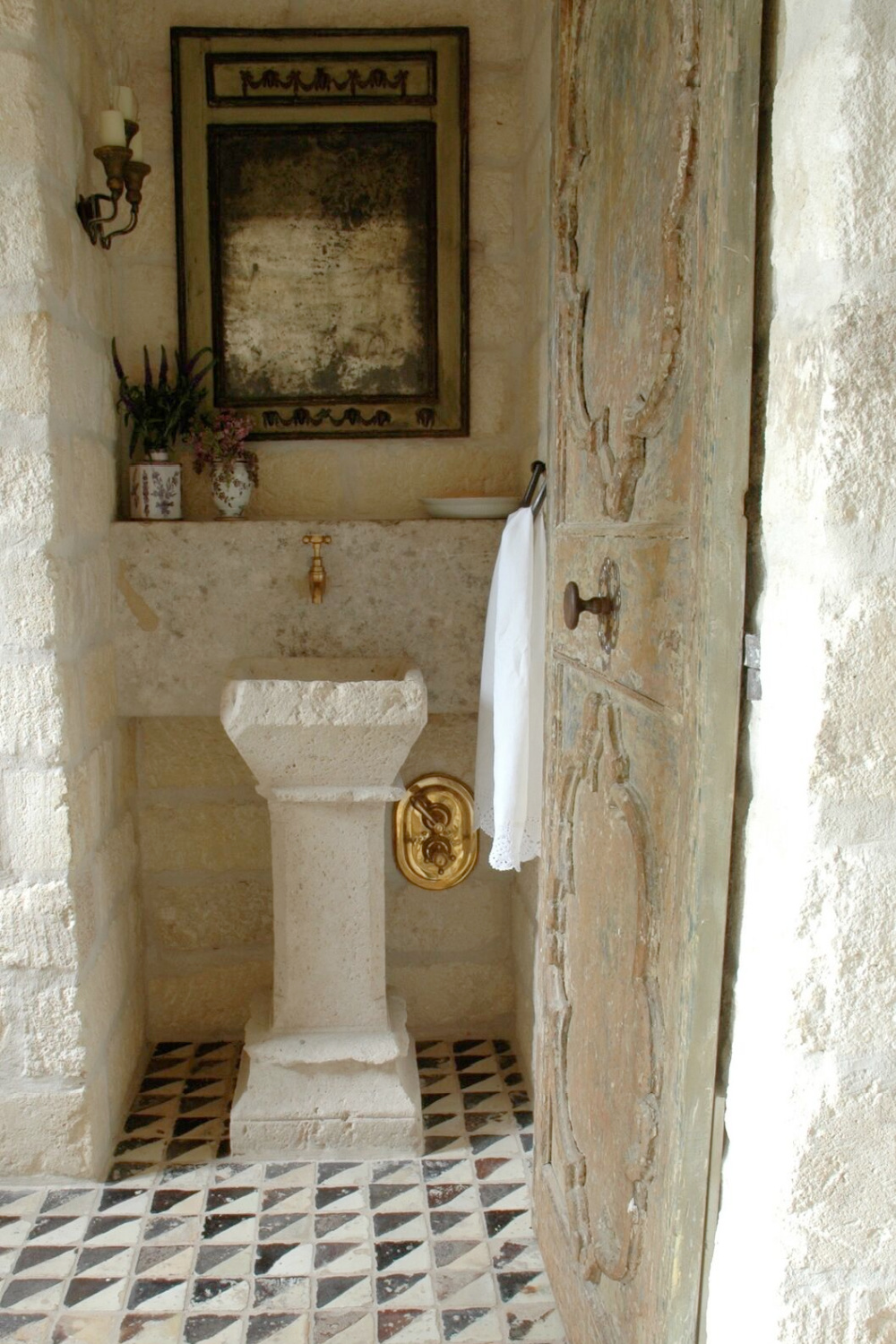 Reclaimed stone, antique doors and mantels, and one of a kind architectural elements. #housetour #frenchcountry #frenchfarmhouse #europeanfarmhouse #chateaudomingue #rusticdecor #pamelapierce #elegantdecor #bathroom #antiques #stone