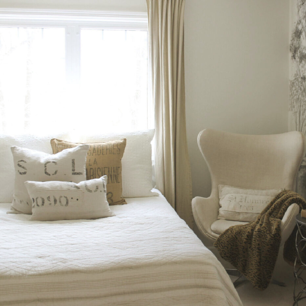 Belgian linen and European country style in a guest bedroom with egg chair - Hello Lovely Studio. #eggchair #belgianlinen #copenhagenchair