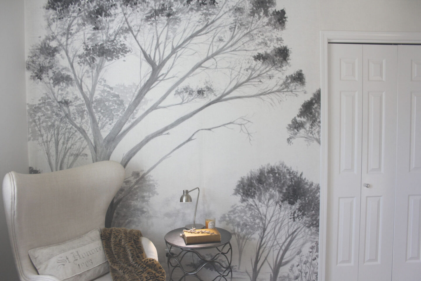 Lovely grisaille mural wallpaper from Photowall with grey trees on a white ground. I created a DIY accent wall in a guest bedroom, and the mood is timeless, serene and tranquil - Hello Lovely Studio. #wallpaper #mural #interiordesign #hellolovelystudio #grisaille #treewallpaper