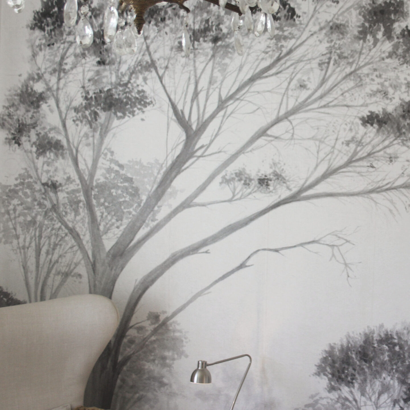 Lovely grisaille mural wallpaper from Photowall with grey trees on a white ground. I created a DIY accent wall in a guest bedroom, and the mood is timeless, serene and tranquil - Hello Lovely Studio. #wallpaper #mural #interiordesign #hellolovelystudio #grisaille #treewallpaper