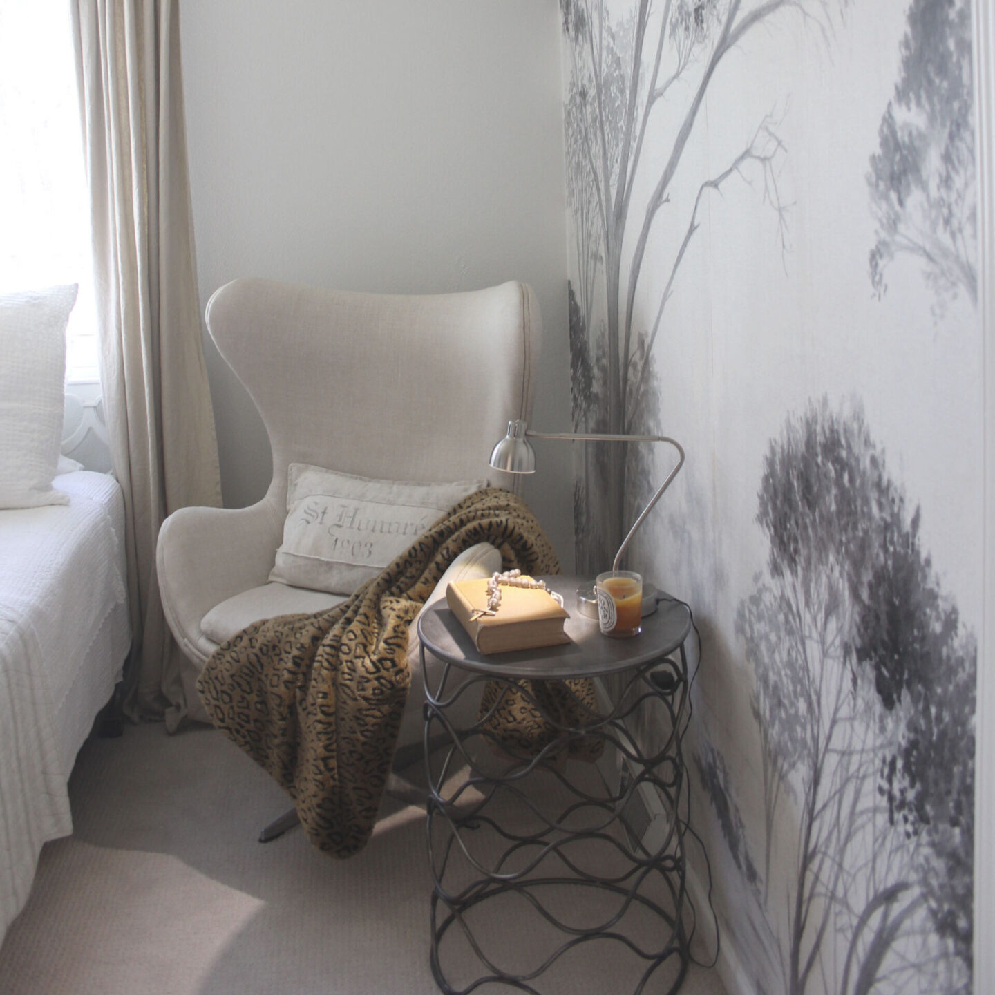 Lovely grisaille mural wallpaper from Photowall with grey trees on a white ground. I created a DIY accent wall in a guest bedroom, and the mood is timeless, serene and tranquil - Hello Lovely Studio. #wallpaper #mural #interiordesign #hellolovelystudio #grisaille #treewallpaper