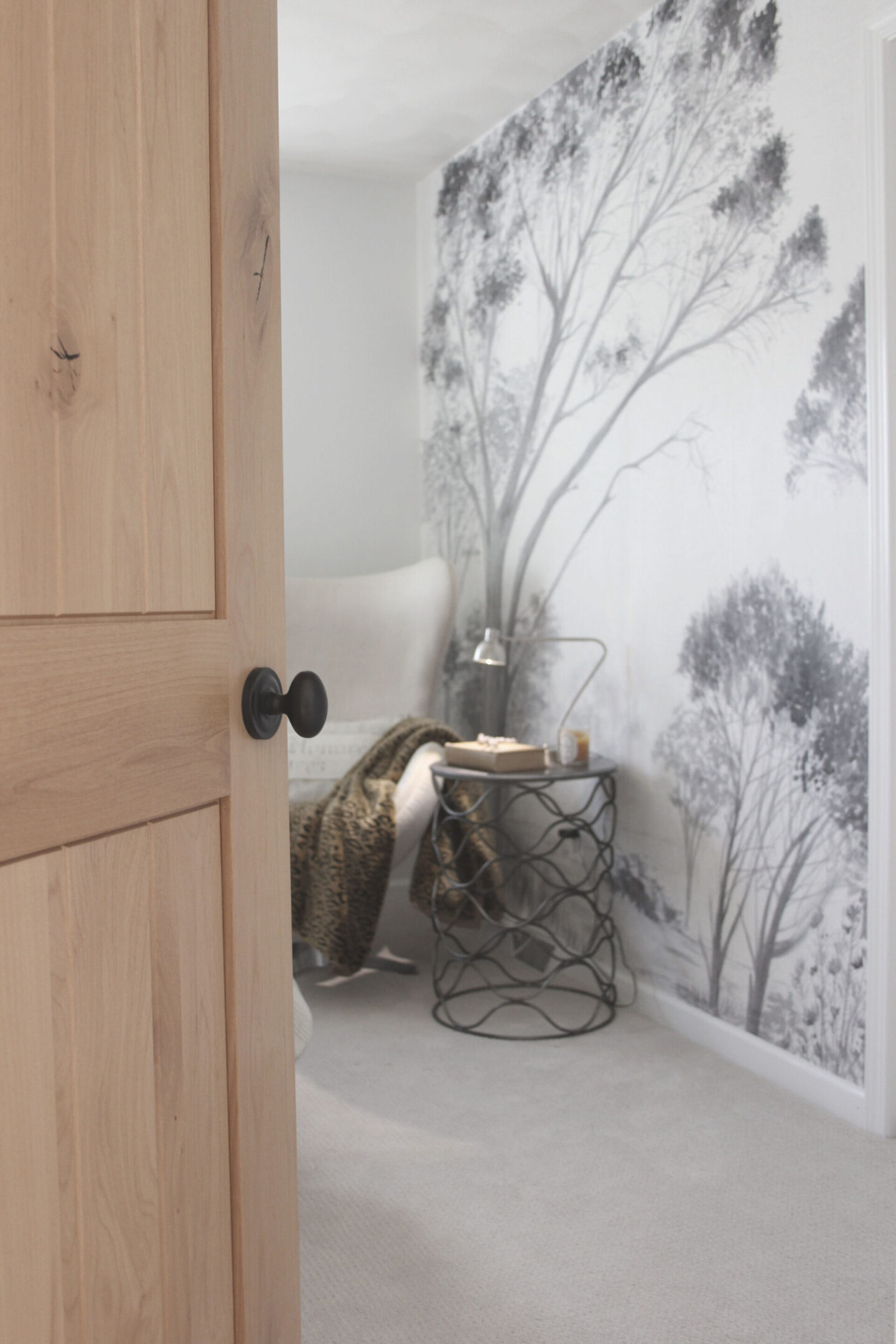 Lovely grisaille mural wallpaper from Photowall with grey trees on a white ground. I created a DIY accent wall in a guest bedroom, and the mood is timeless, serene and tranquil - Hello Lovely Studio. #wallpaper #mural #interiordesign #hellolovelystudio #grisaille #treewallpaper