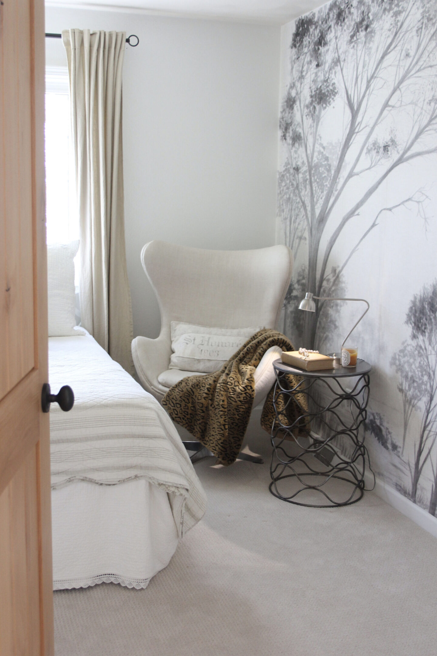 Subdued, understated, and serene, a tone on tone wall covering with gray trees sets a calm tone in a bedroom - Hello Lovely Studio. #wallcovering #photowall #treewallpaper #hellolovelystudio