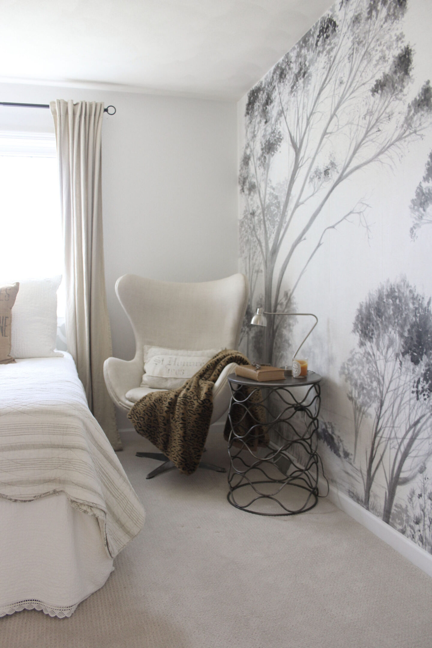 Lovely grisaille mural wallpaper from Photowall with grey trees on a white ground. I created a DIY accent wall in a guest bedroom, and the mood is timeless, serene and tranquil - Hello Lovely Studio. #wallpaper #mural #interiordesign #hellolovelystudio #grisaille #treewallpaper