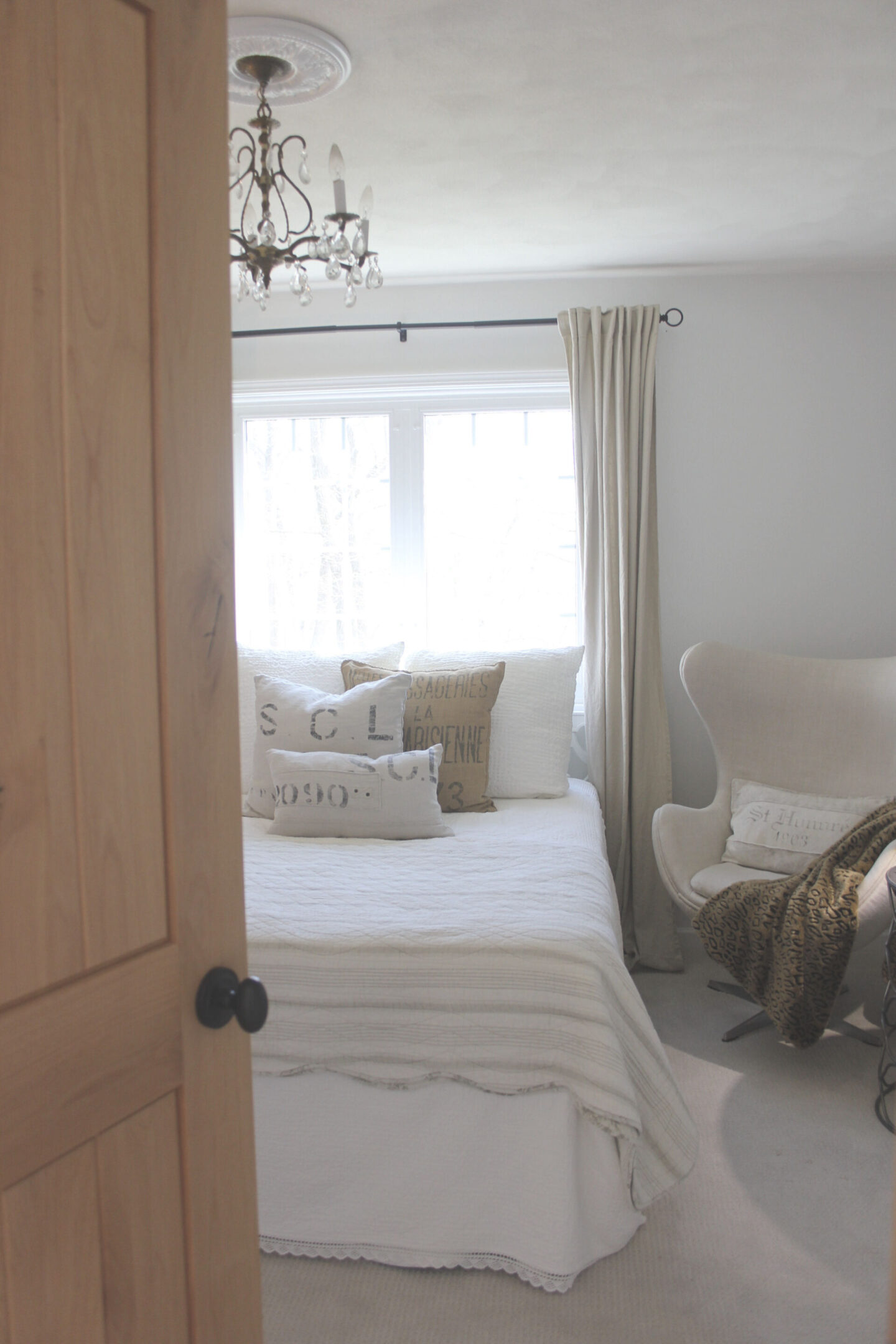 Calm, simple, neutral white bedroom at our fixer upper painted Benjamin Moore White - Hello Lovely Studio. #alderdoor #interiordesign #bedroom