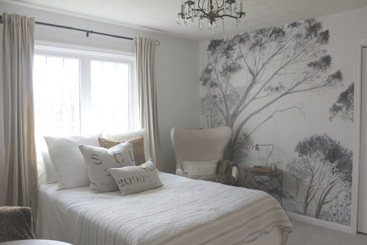 Lovely grisaille mural wallpaper from Photowall with grey trees on a white ground. I created a DIY accent wall in a guest bedroom, and the mood is timeless, serene and tranquil - Hello Lovely Studio. #wallpaper #mural #interiordesign #hellolovelystudio #grisaille #treewallpaper