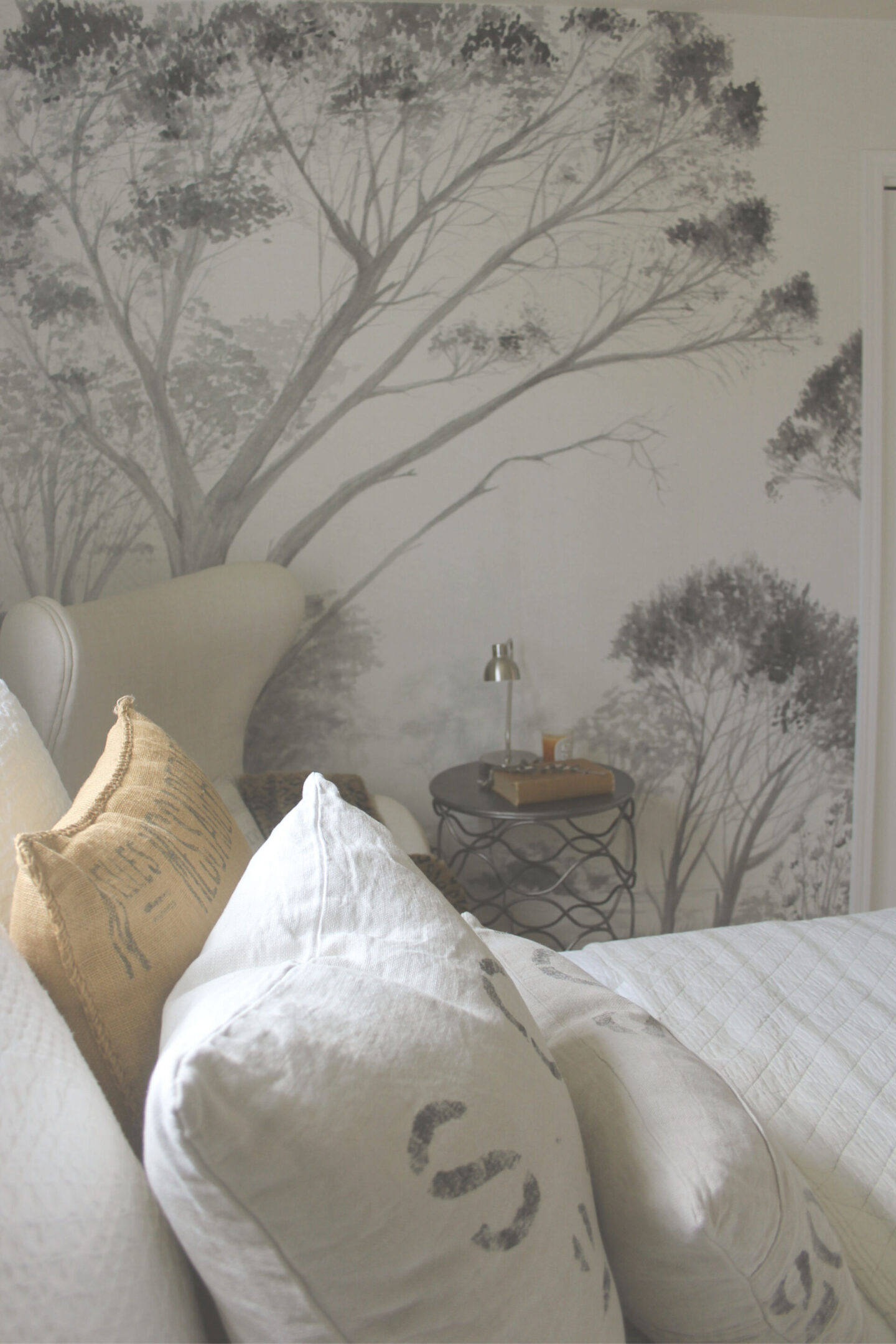 Lovely grisaille mural wallpaper from Photowall with grey trees on a white ground. I created a DIY accent wall in a guest bedroom, and the mood is timeless, serene and tranquil - Hello Lovely Studio. #wallpaper #mural #interiordesign #hellolovelystudio #grisaille #treewallpaper