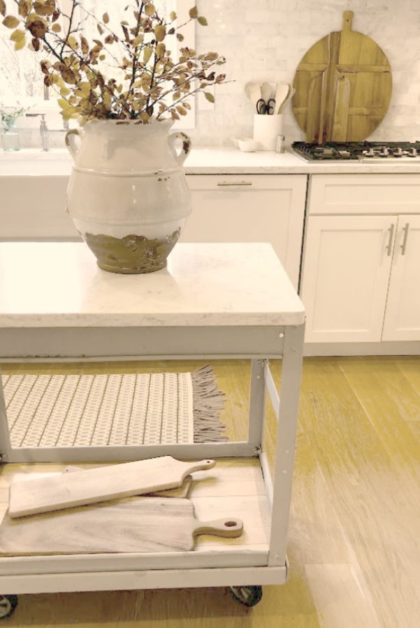 My simple white Shaker kitchen with white oak hardwood floor and vintage work cart - Hello Lovely Studio.