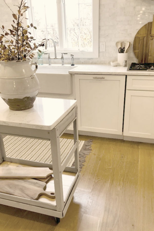 My simple white Shaker kitchen with white oak hardwood floor and vintage work cart - Hello Lovely Studio.