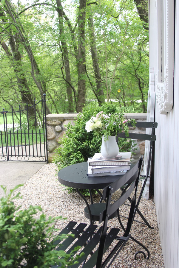 Parisian Café Chairs in our French country courtyard with boxwood and pea gravel. #hellolovelystudio #cafechairs #frenchcountry #bistrochairs #outdoorfuniture #frenchcountrydecor #modernfrench #hellolovelystudio