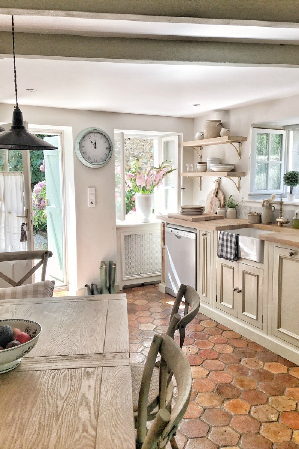 Charming French kitchen with reclaimed terracotta tile floor. French farmhouse design inspiration with an interview with Vivi et Margot. Come be inspired on Hello Lovely and learn the paint colors used in these beautiful authentic French country interiors. #frenchkitchen #frenchfarmhouse #hellolovelystudio #frenchcountry #designinspiration #interiordesign #vivietmargot #rusticdecor #frenchhome #summerliving #bordeaux #europeanfarmhouse