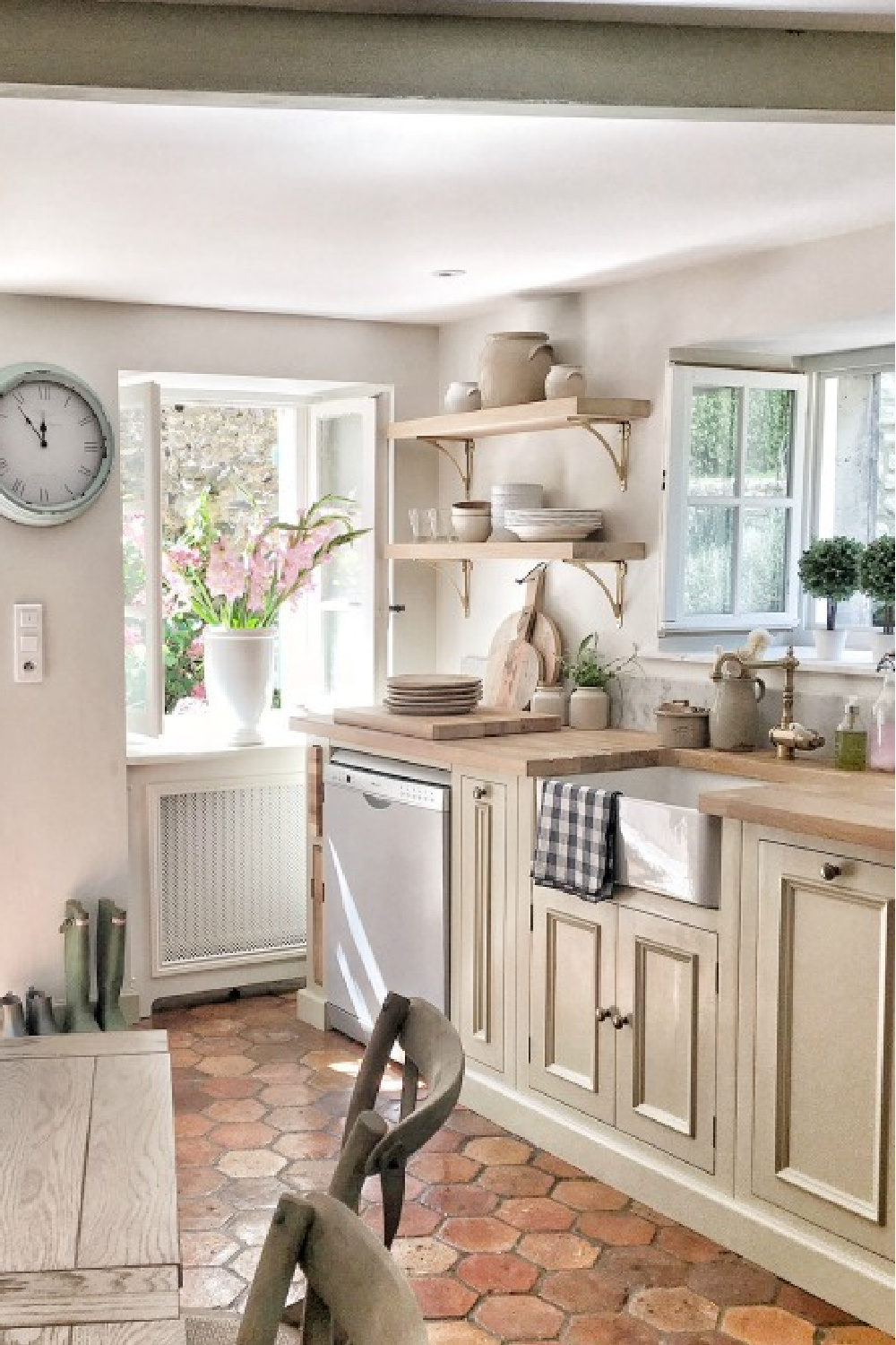 Kitchen in France with antique reclaimed hex tiles, putty cabinets, and farm sink. #frenchkitchen #frenchfarmhouse #countryfrench #kitchens #oldworldstyle #terracottatile #puttycabinets