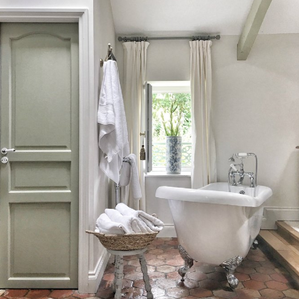 Farrow & Ball Strong White and French Gray in a lovely rustic French farmhouse bathroom. #frenchfarmhouse #bathroomdesign #oldworldstyle #farrowandballstrongwhite #farrowandballfrenchgray #clawfoottub