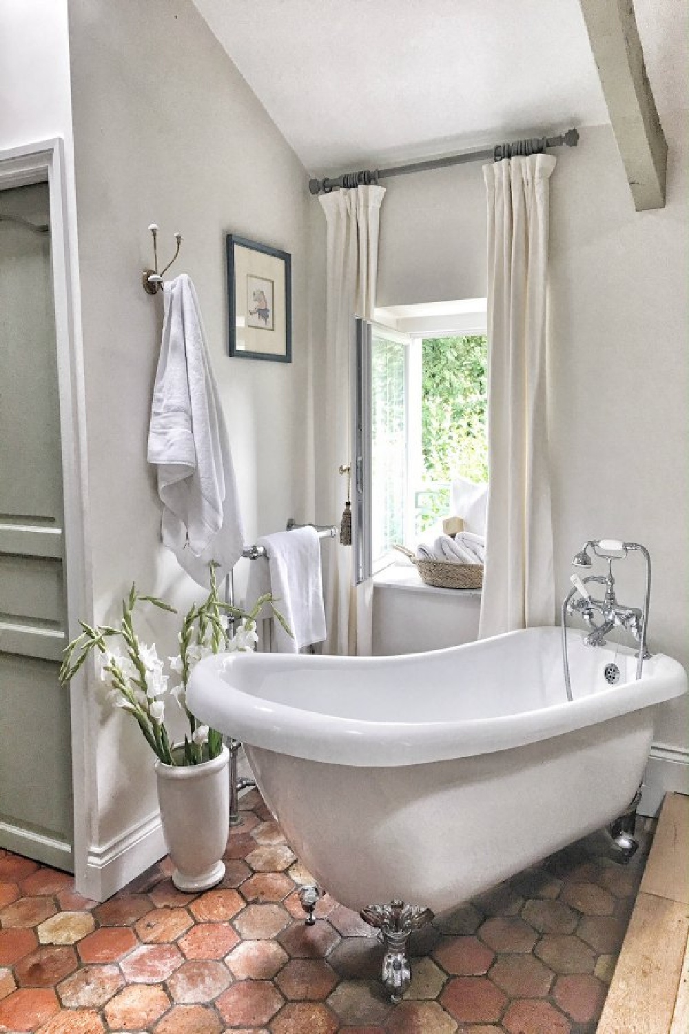 Farrow & Ball Strong White walls in a charming French bathroom with clawfoot tub. #farrowandball #strongwhite #frenchfarmhouse #bathroom #paintcolors #clawfoottub