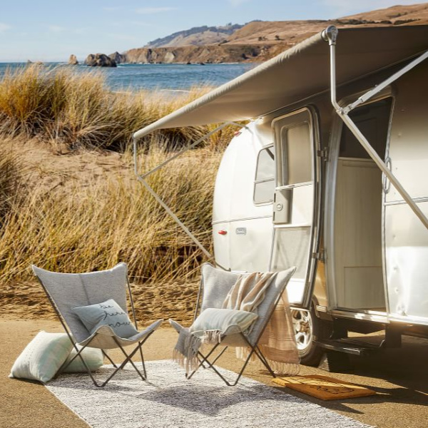 Blissful and serene camping retro camper scene. Airstream at Pottery Barn is a lovely collection of whimsical and happy camper decor whether we have a vintage camper to put in or not! #airstream #retrocampers #vintagecamper #camplife