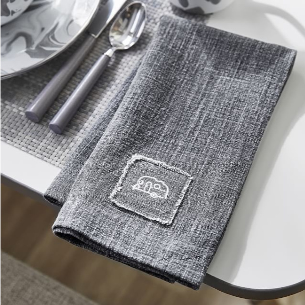 Grey napkins with camper motif. Airstream at Pottery Barn is a lovely collection of whimsical and happy camper decor whether we have a vintage camper to put in or not! #airstream #potterybarn #happycamper #whimsicalgifts #vintagecamper #homedecor