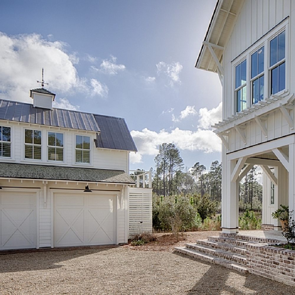 Board and batten coastal cottage exterior of a home in Palmetto Bluffs with interiors by Lisa Furey. #coastalcottage #boardandbatten #houseexteriors #whitecottage